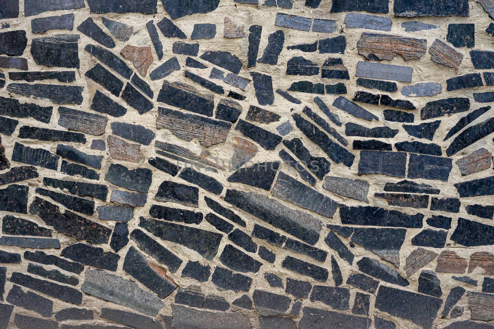 The wall of the house is lined with granite tiles. Tiles and cement