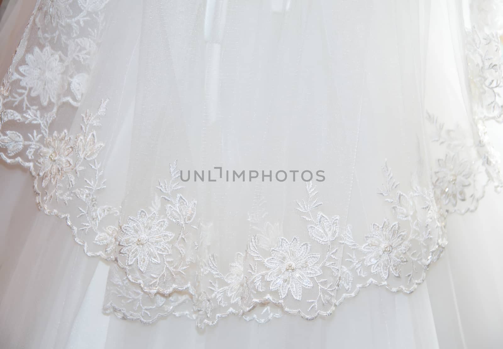 Part of the bride's white dress is decorated with embroidery by Serhii_Voroshchuk