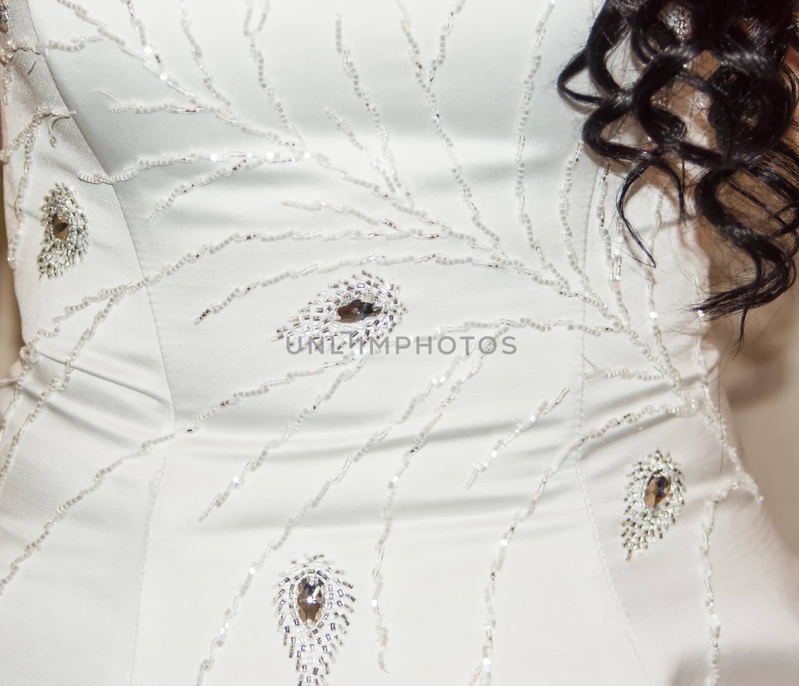 Part of the bride's white dress is decorated with embroidery