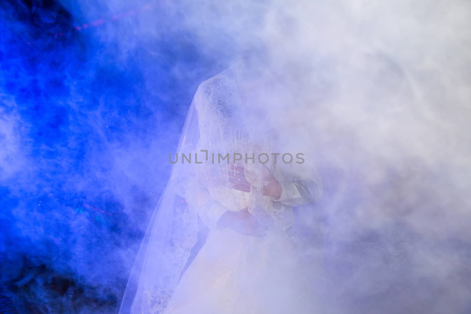 Brides dance a slow dance. Heavy smoke at the wedding. Soft focus by Serhii_Voroshchuk