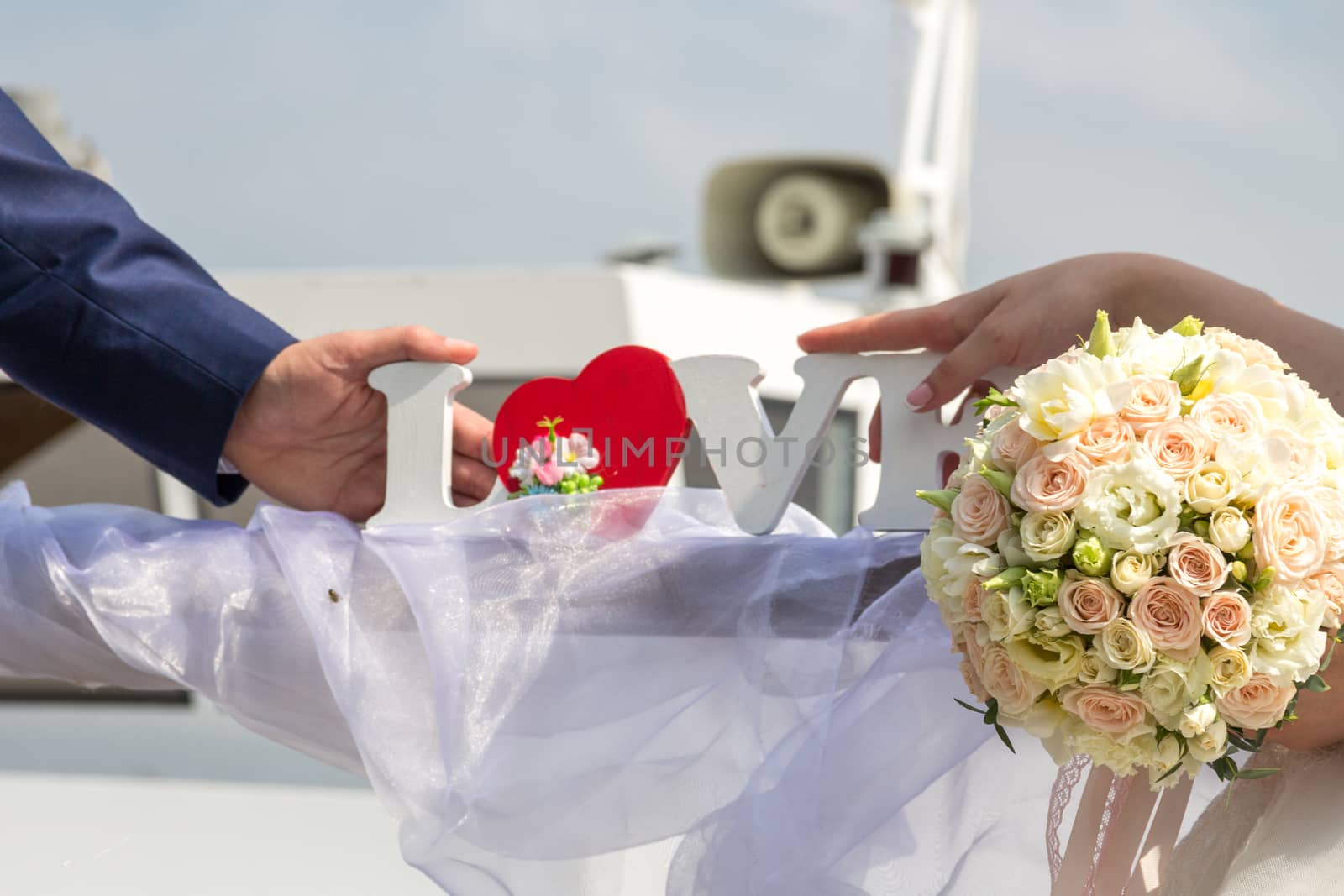 Brides hold love in their hands. Wedding bouquet. Blurred background