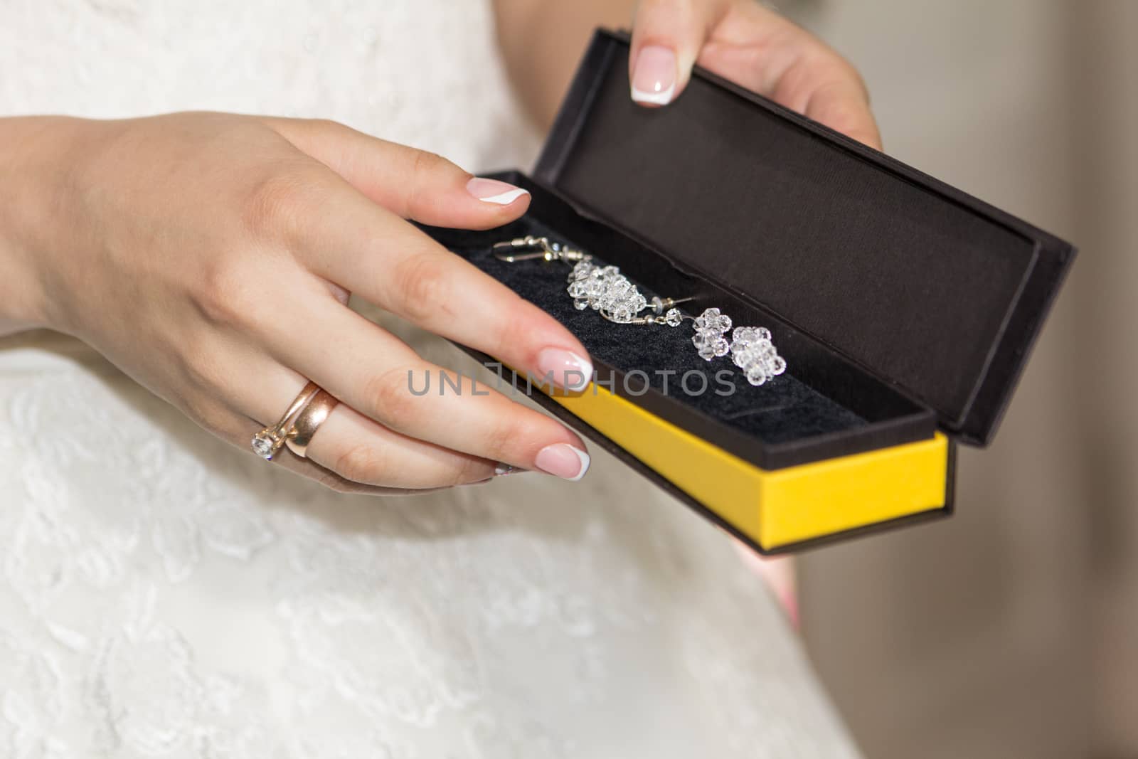 The bride holds jewelry in her hands. Jewelry of the bride. Preparing for the wedding. Box with jewelry in the hands of the bride by Serhii_Voroshchuk