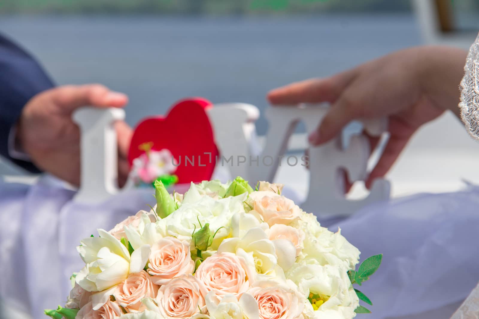 Brides hold love in their hands. Wedding bouquet. Blurred background