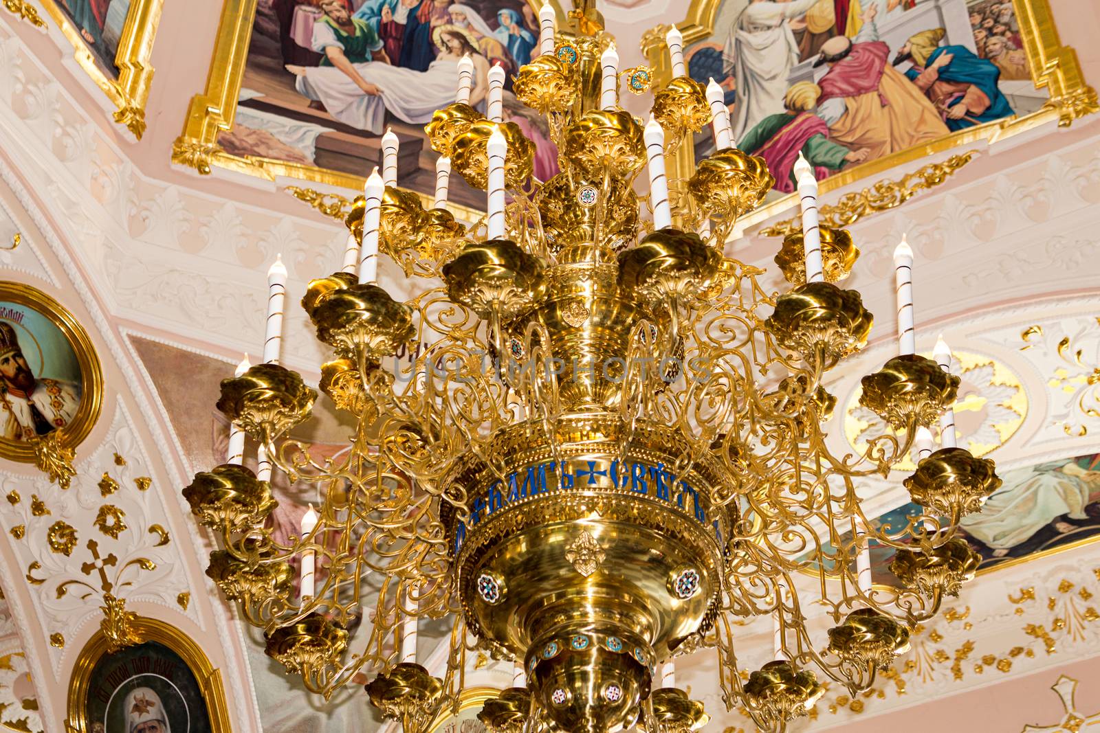 Large gilded chandelier in the temple of God on the background of icons and murals by Serhii_Voroshchuk