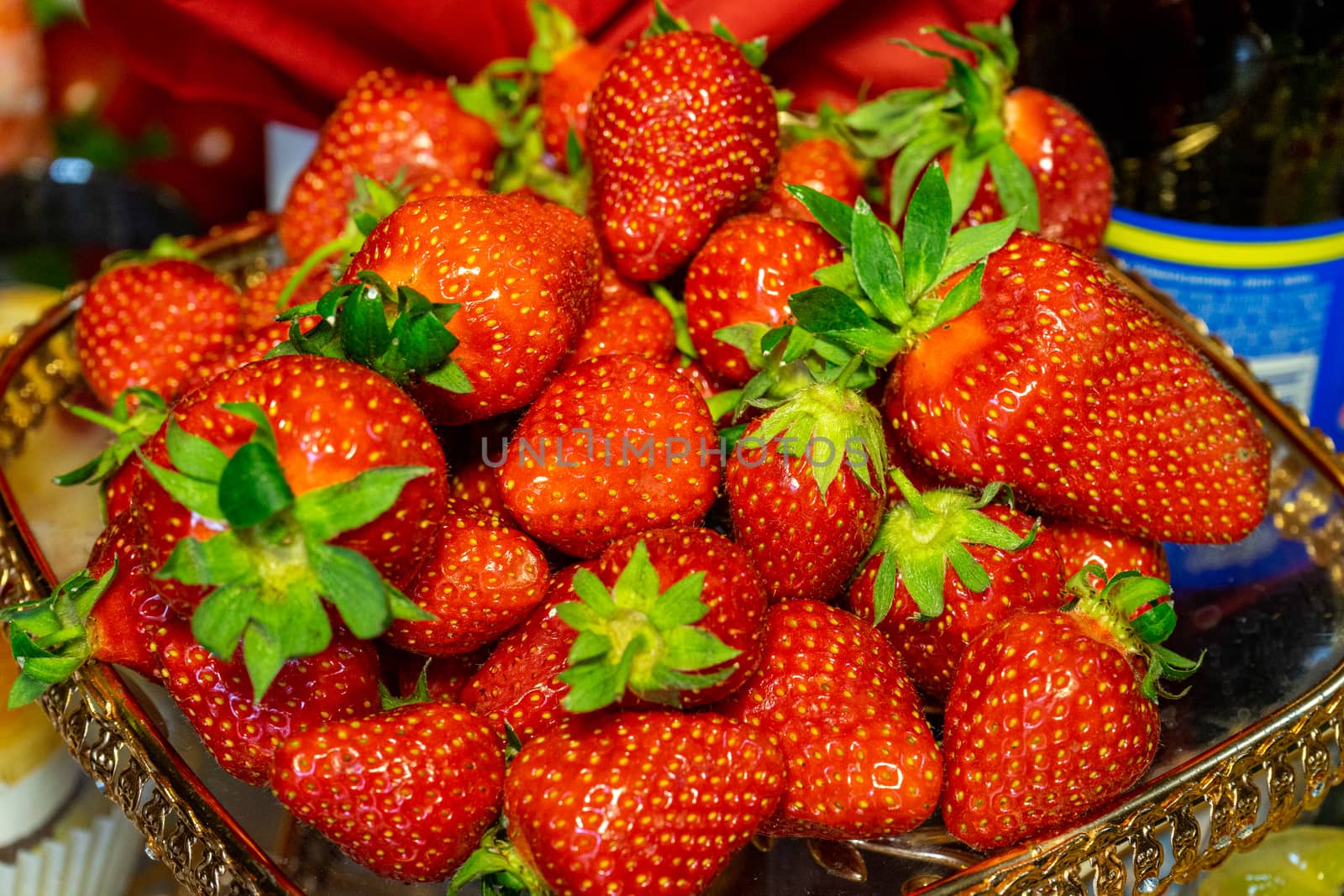 Red fresh strawberries lie on a slide on a beautiful plate