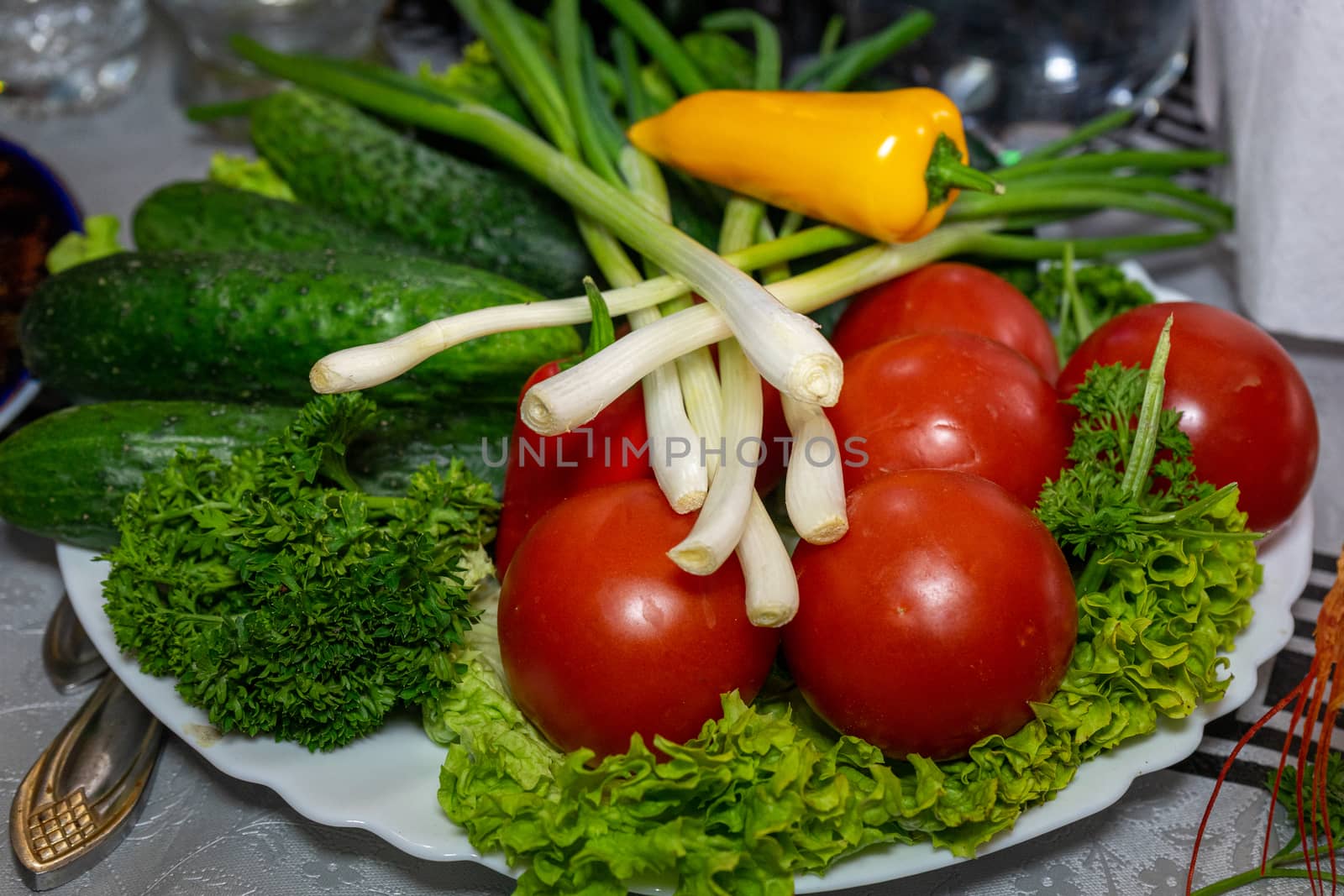 Fresh vegetables on a plate. Vegetarian food. Tomatoes, cucumbers, onions, parsley by Serhii_Voroshchuk