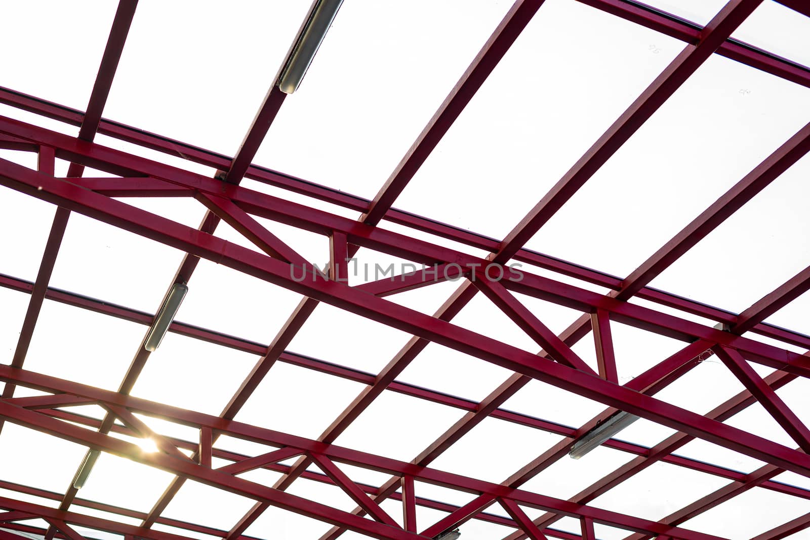 The glass roof is mounted on a metal frame which is painted red