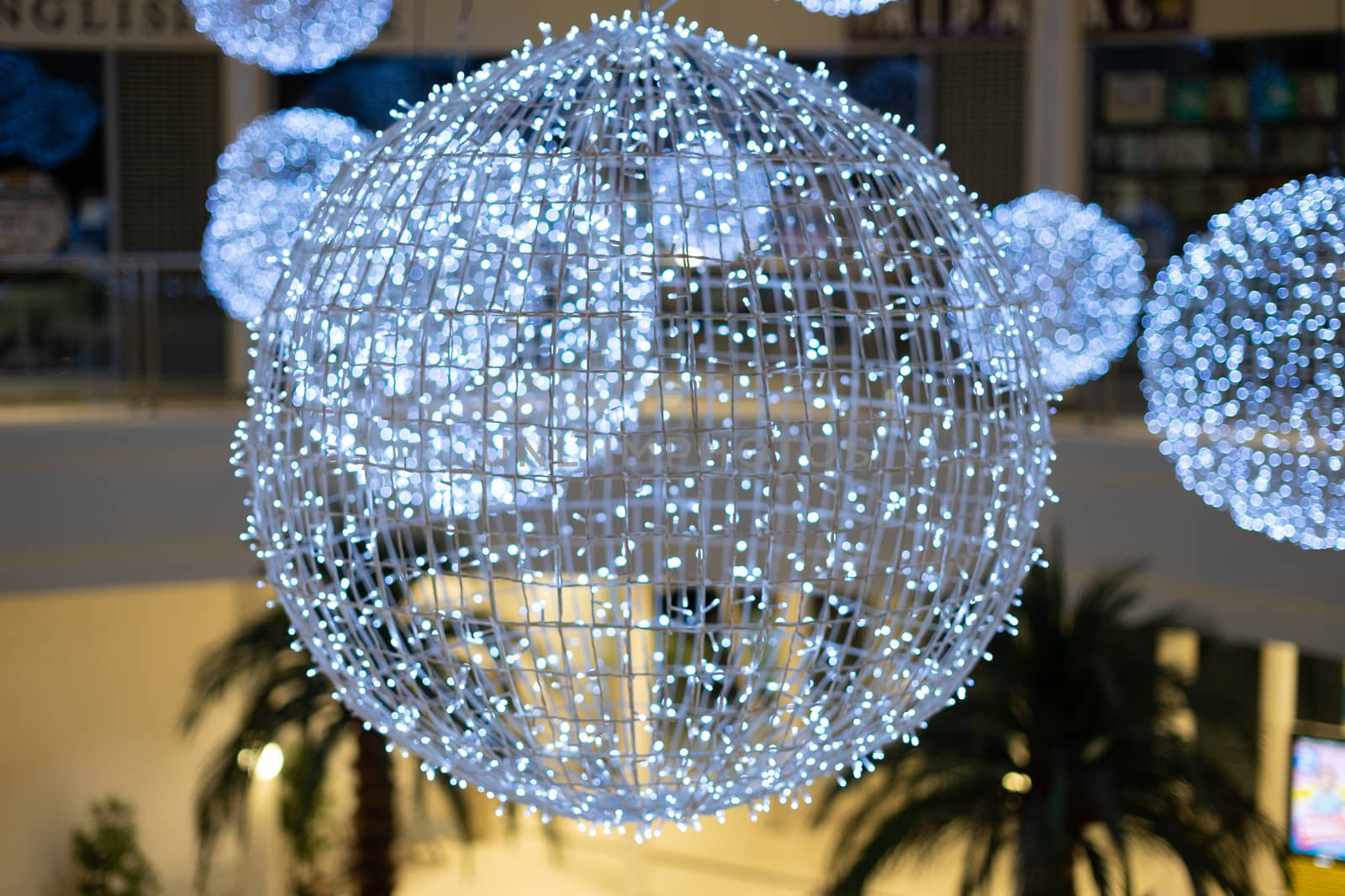 big bright balls with garlands. balls with white lights. decorations in the mall