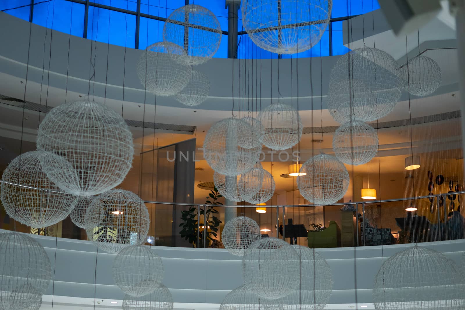 large balls with garlands off. balls under the ceiling of the mall. decorations in the mall