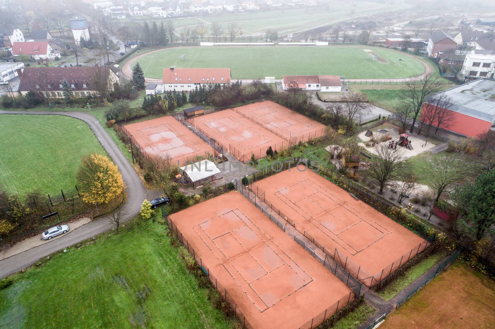 Aerial view of tennis courts during autumn with dismantled nets. by geogif