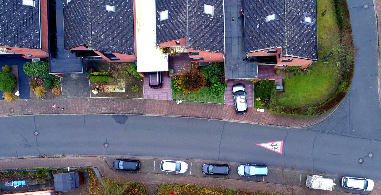 Single-family houses with parking cars in a suburb, aerial photo by geogif