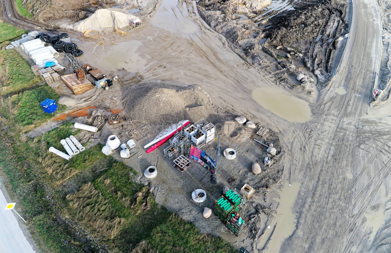 Aerial photograph of the material store for canal construction work on the construction site of a new development area, photographed with the drone