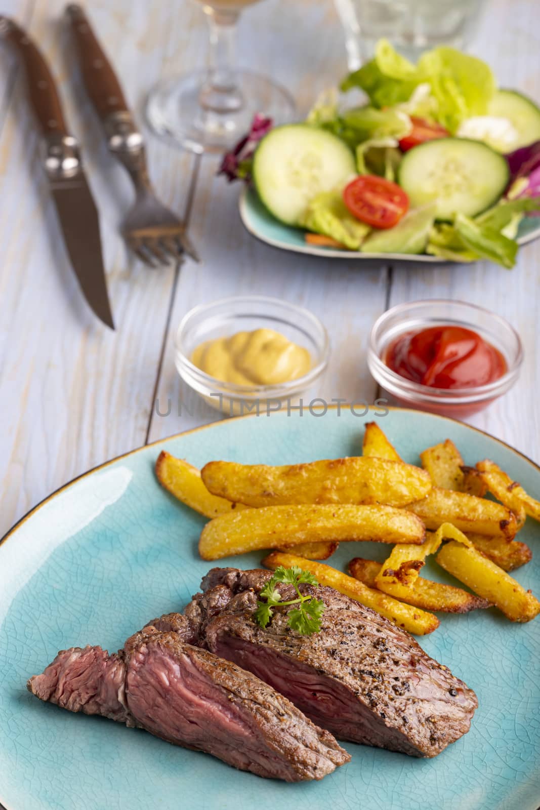 steak on a plate with french fries by bernjuer