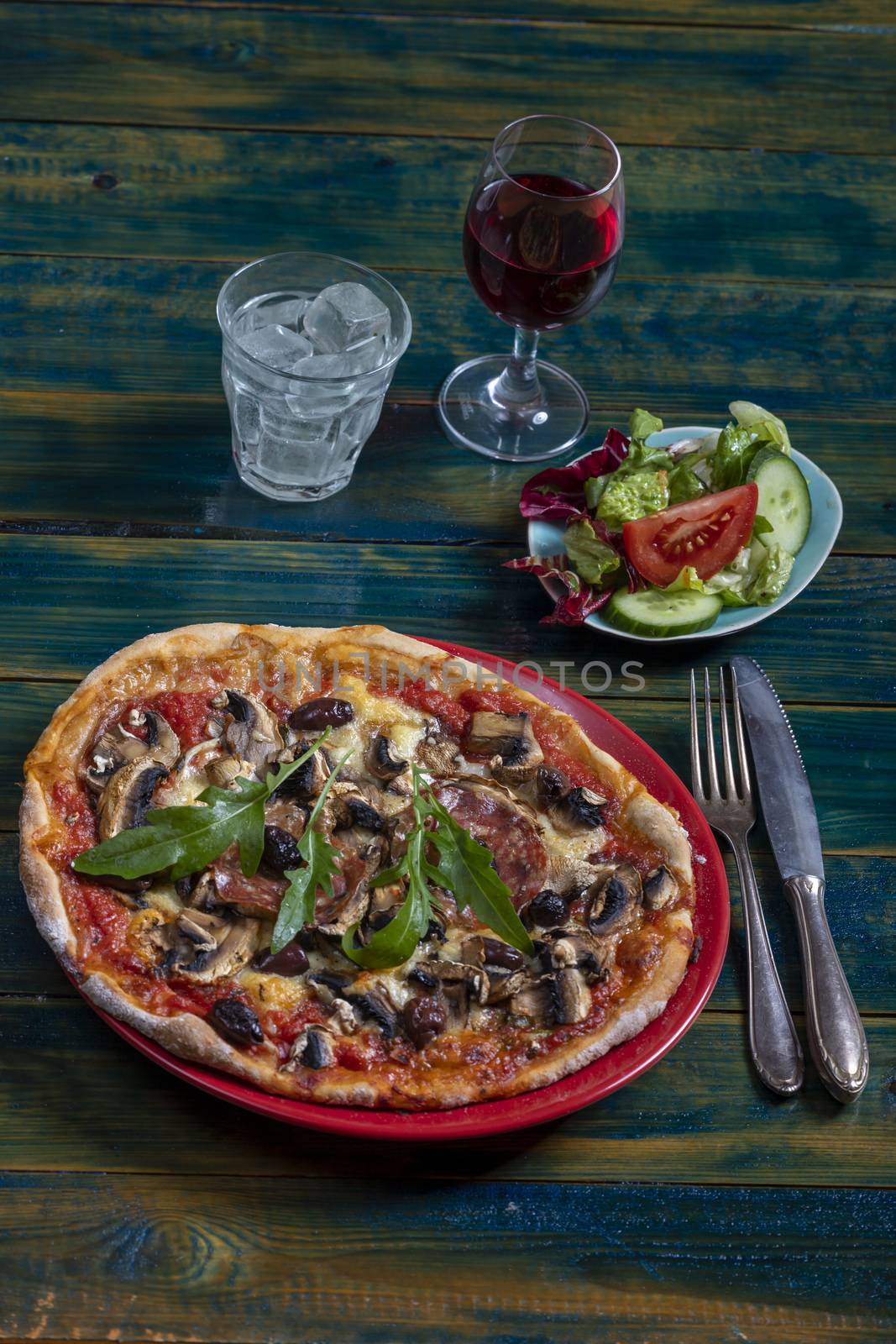 overview of a pizza with salad