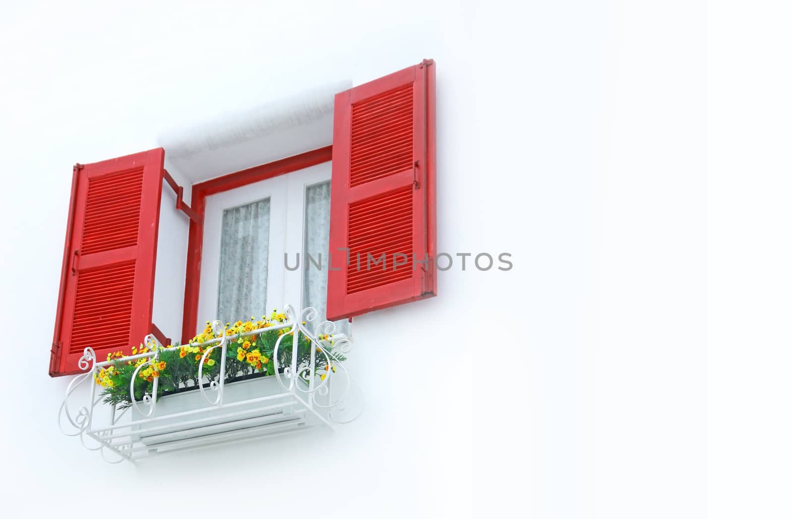 outer opened red and white inner closed window with white wall decorated with flowerpod