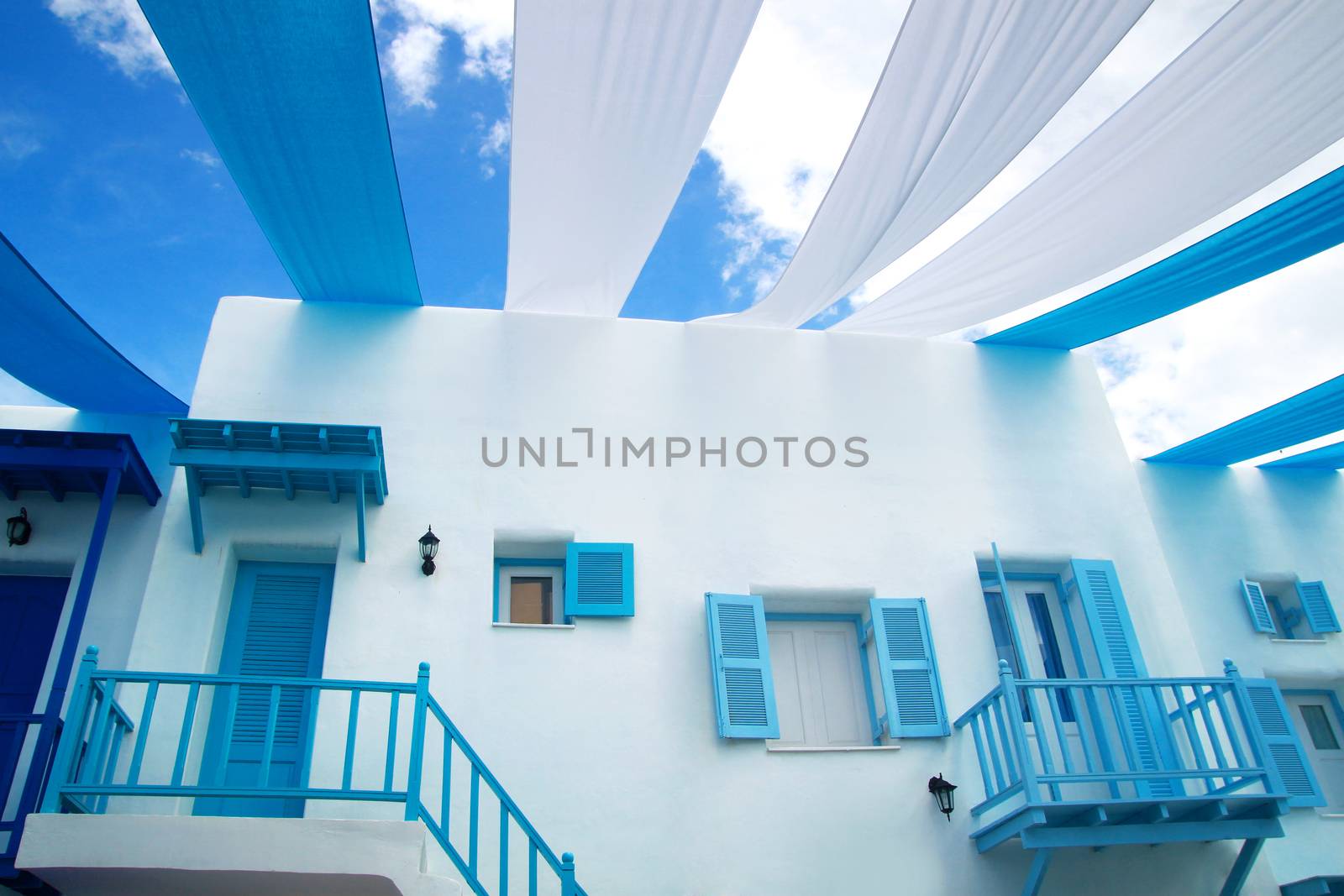 dream vacation concept. white blue building at Santorini Island horizontal background by asiandelight