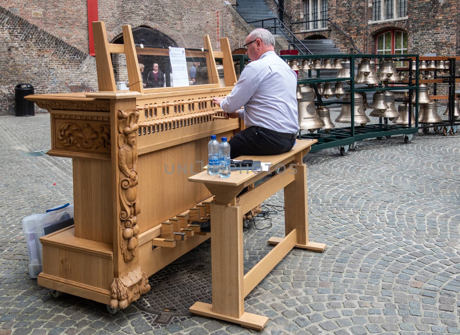 Musician plays the carillon in Bruges, Flanders, Belgium. by Claudine