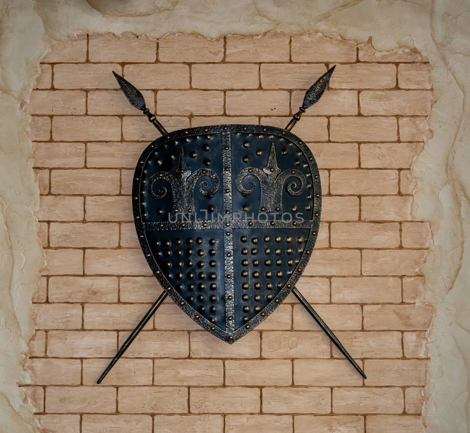 Design of an ancient castle. Brick wall. Shield and spears on the wall. Ancient style.