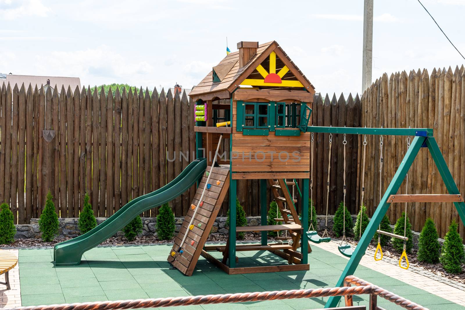 Wooden house on the playground. A small playground. Children's wooden house. Children's swing by Serhii_Voroshchuk