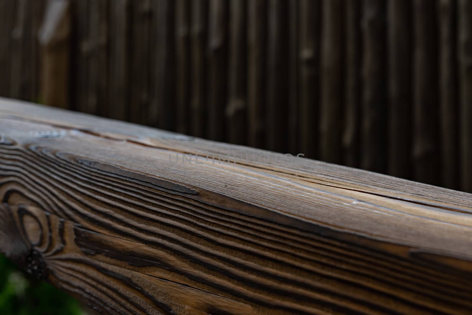 Wooden products. Wooden beam. Wooden railings near the stairs close up. Blurred background. Soft focus