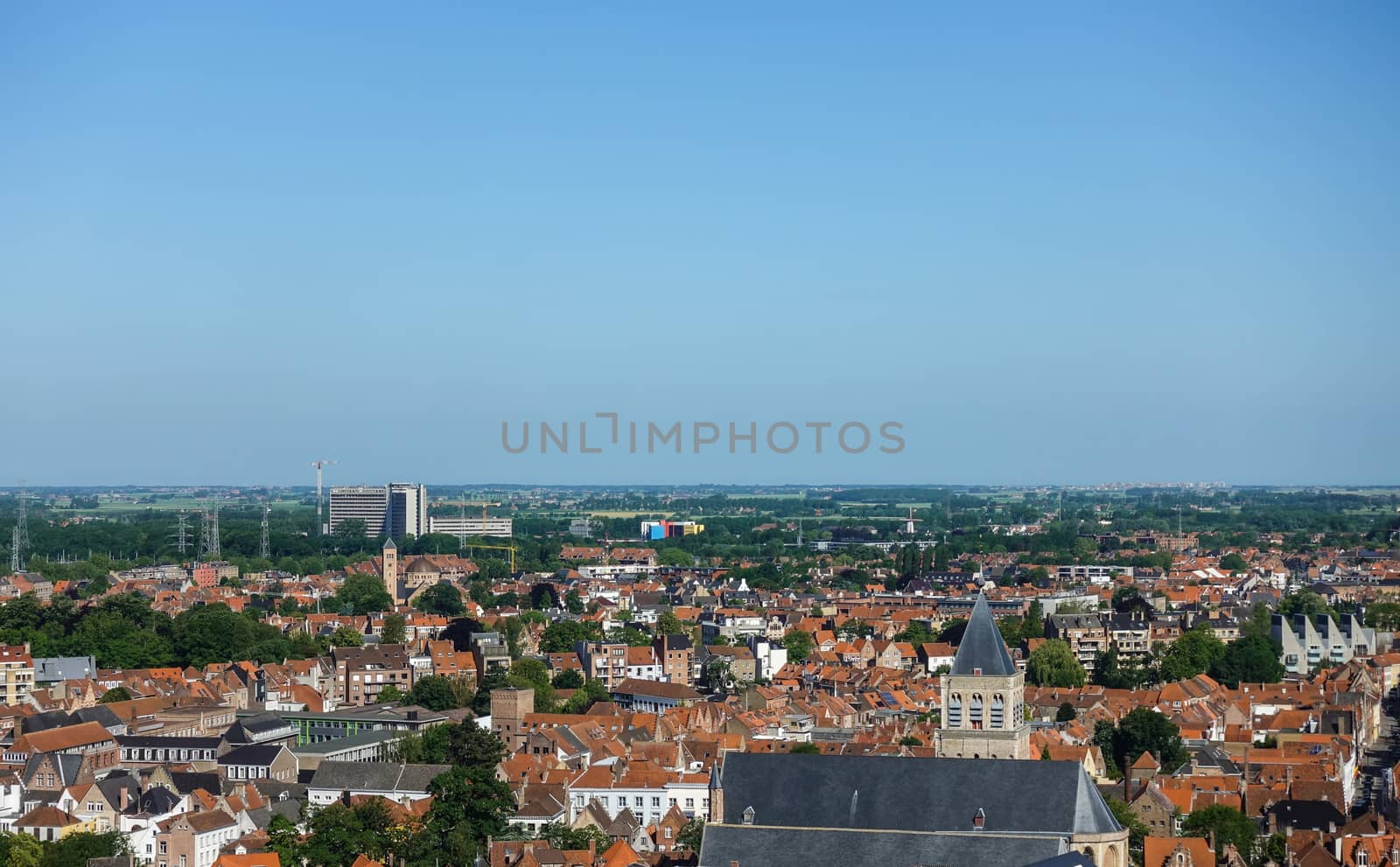 Bruges, Flanders, Belgium -  June 17, 2019: View North from top of Belfry tower, Halletoren, towards new AZ Sint Jan. Red roofs, large highrise block of the clinic, North Sea and flat country.