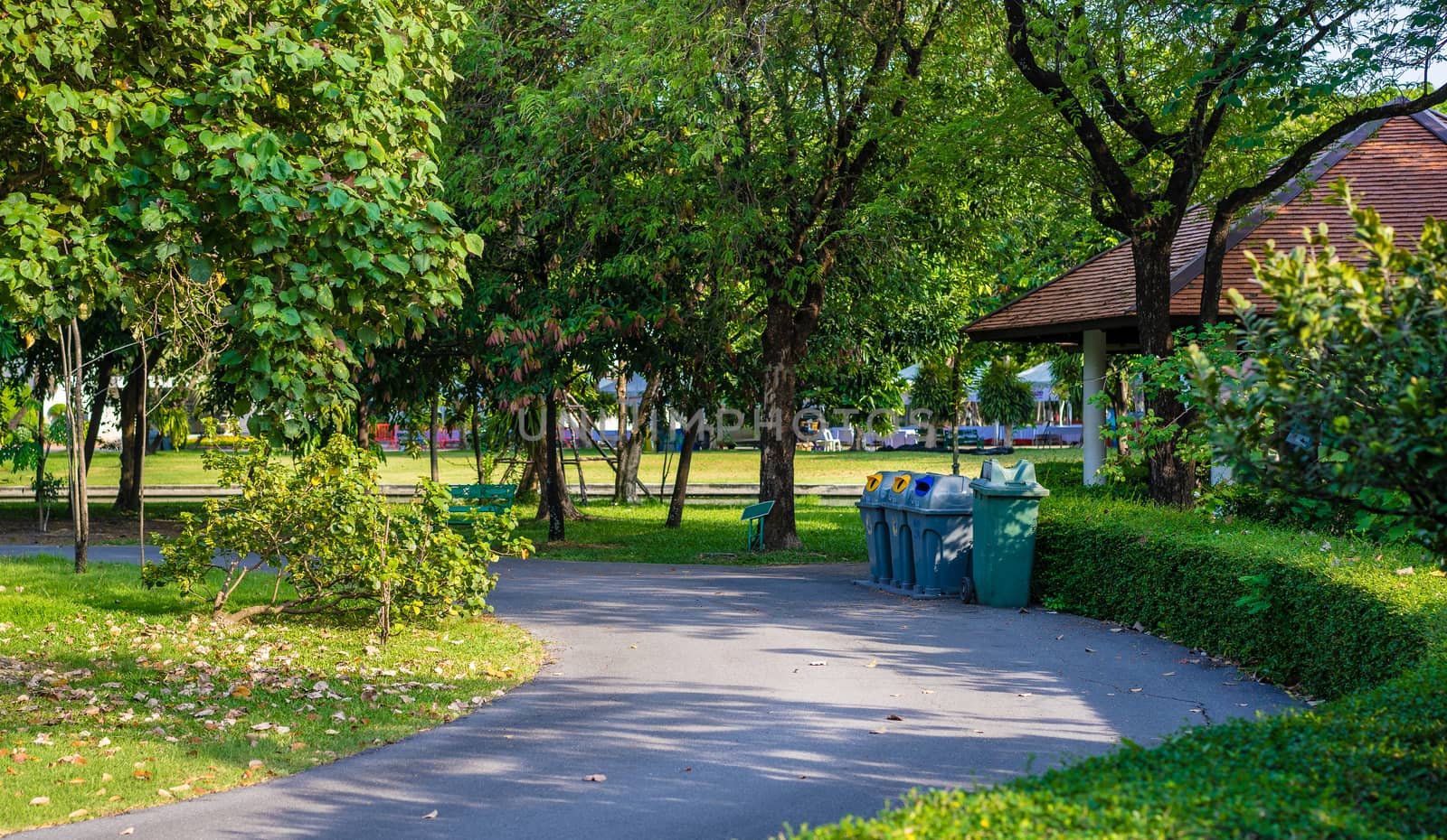 trashcans in a park with green tree and plants background in public park