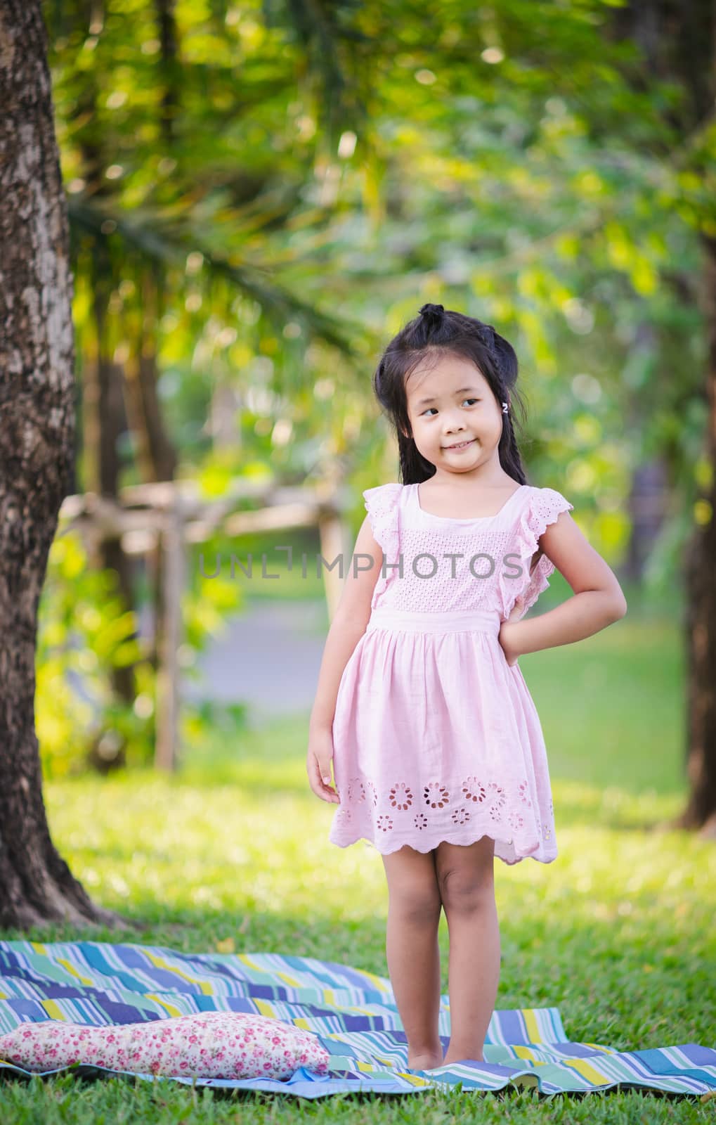 portrait of cute little girl standing in the park