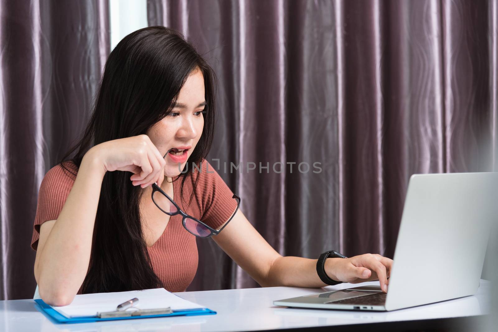 Work from home, Fatigued or strain Asian business young beautiful woman sits on desk workspace feeling tired stressed hold his nose close eyes after see screen long time of laptop computer at office