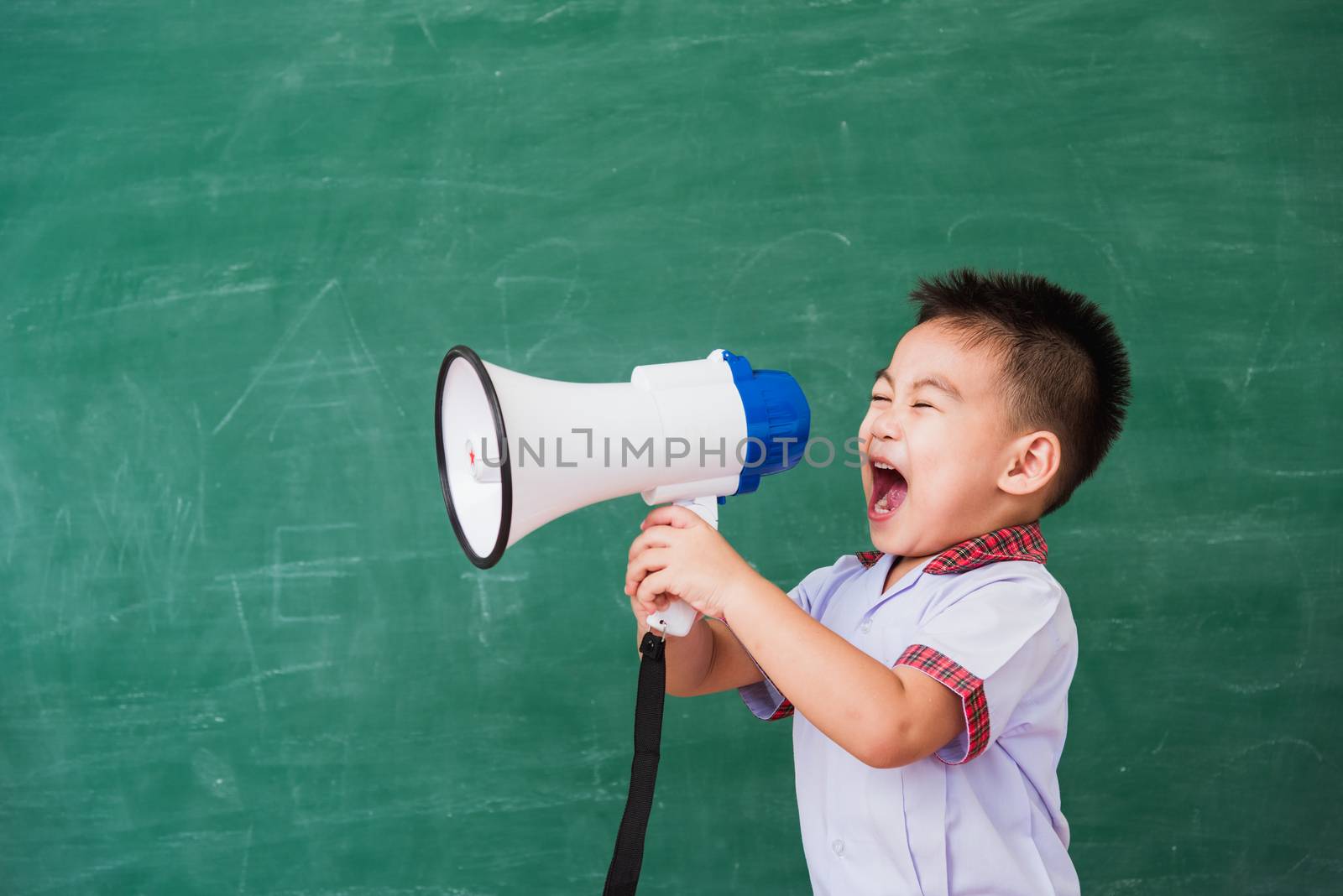 child boy kindergarten preschool in student uniform speaking thr by Sorapop