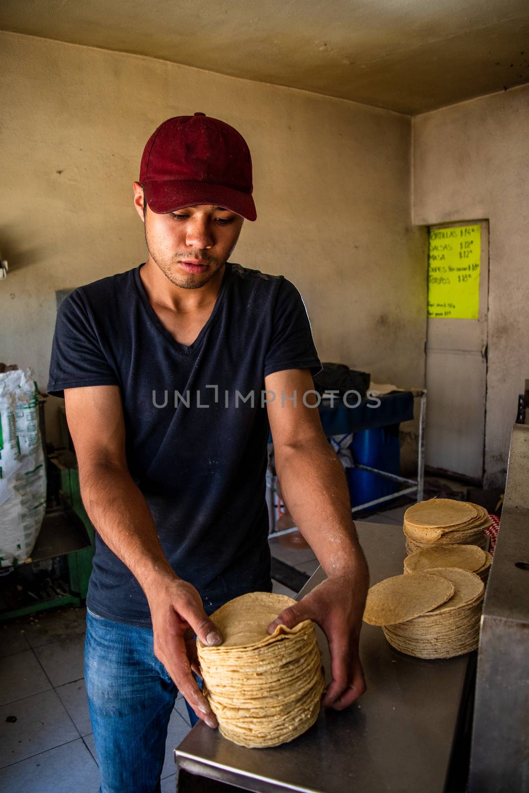 young man selling tortillas of nixtamal by Tonhio