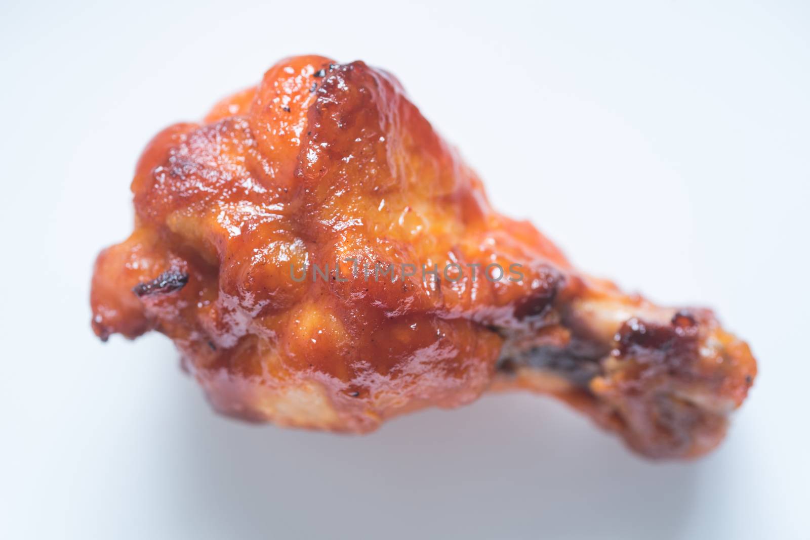 spicy BBQ chicken wing on white background