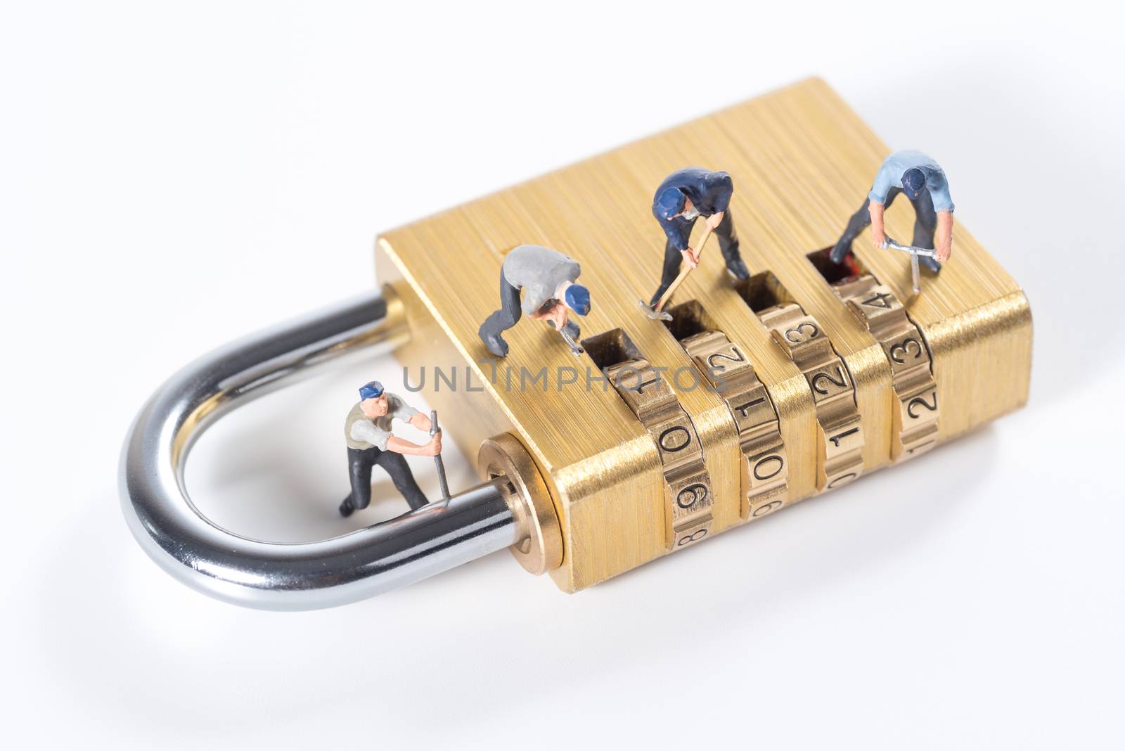 miniature people try to unlock metal security lock key