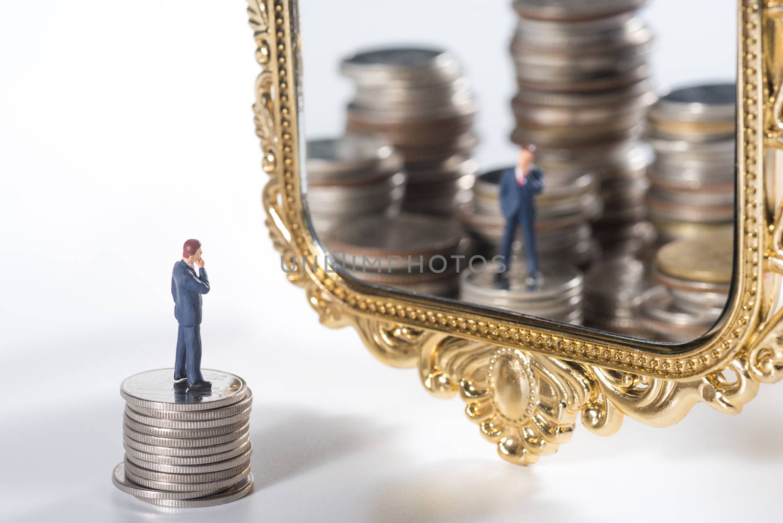 miniature businessmen see themselves as wealthy in the mirror