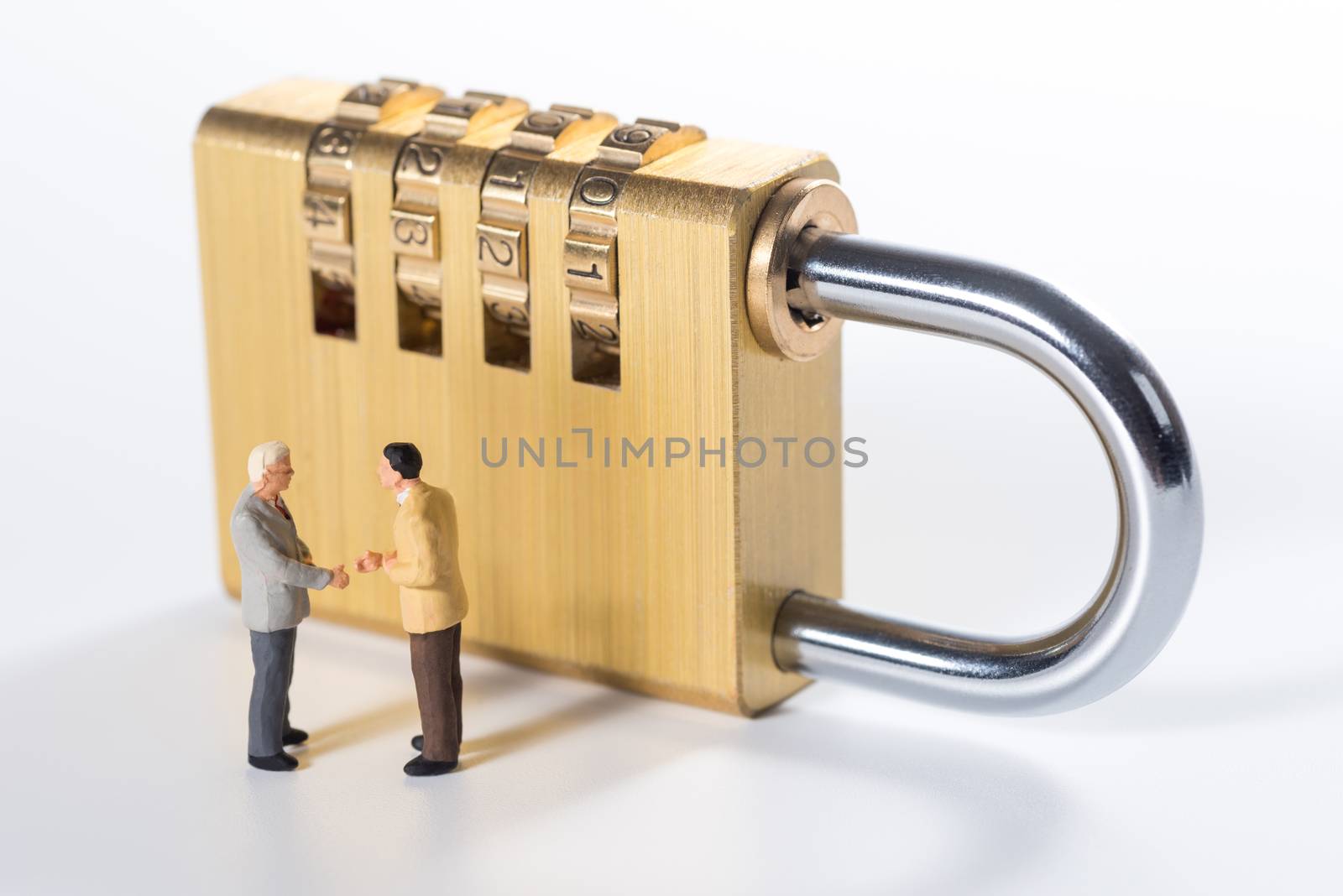 business miniature people try to unlock security lock key