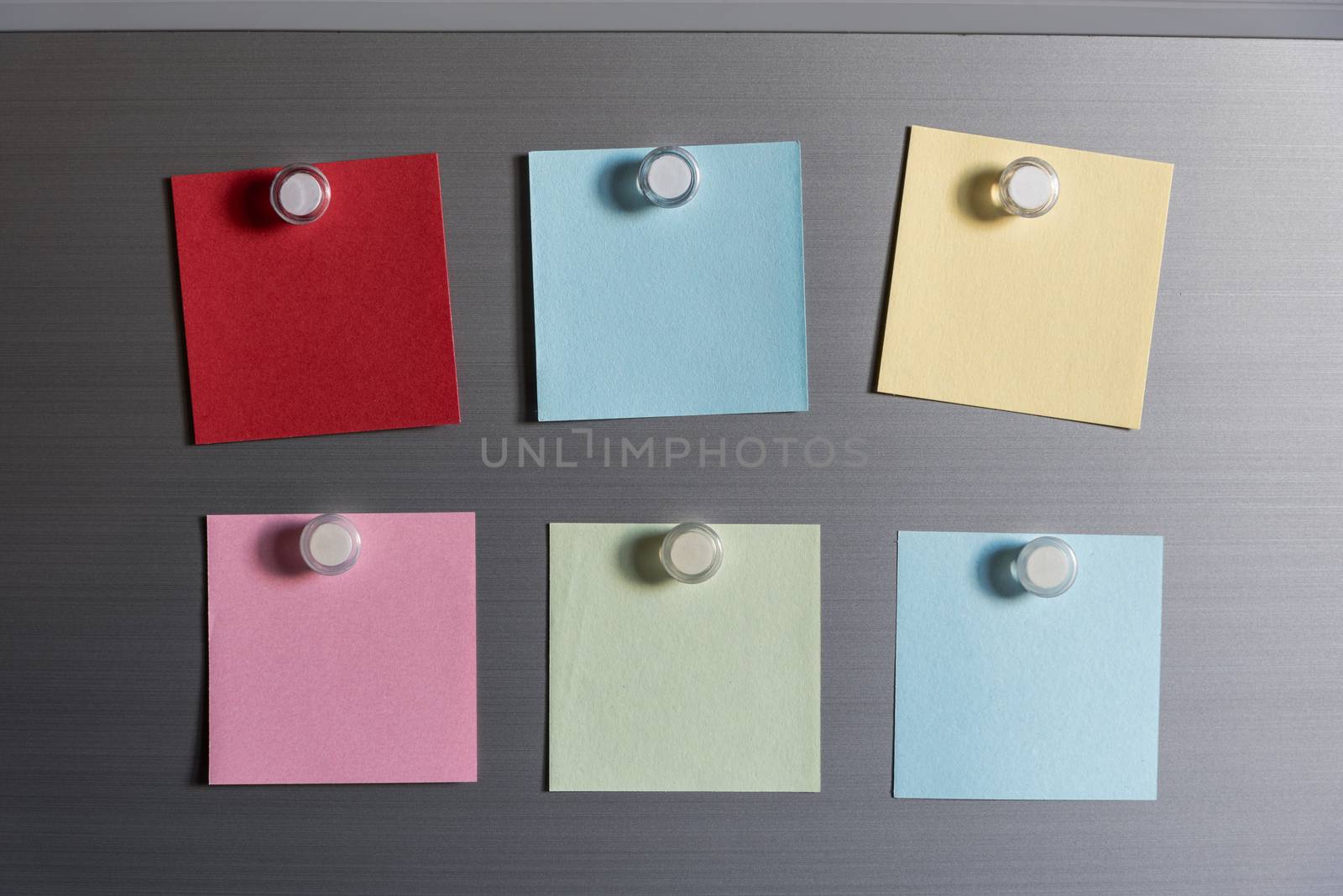 colorful magnet sticky notes on refrigerator door background