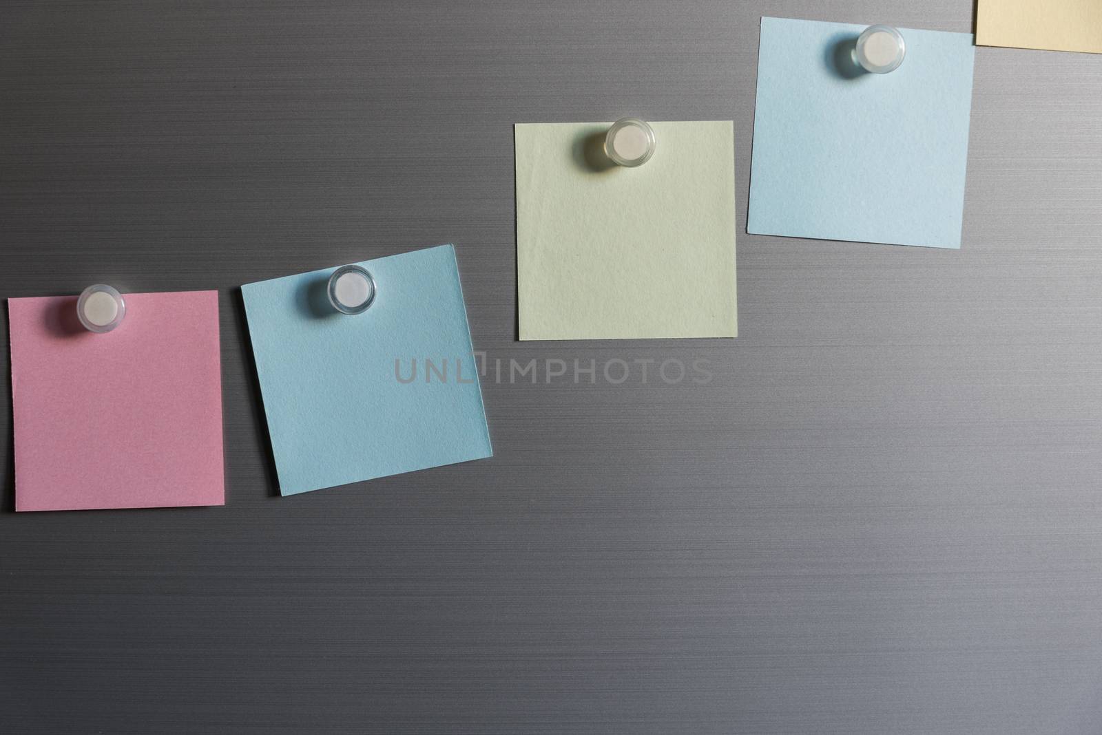 colorful magnet sticky notes on refrigerator door background
