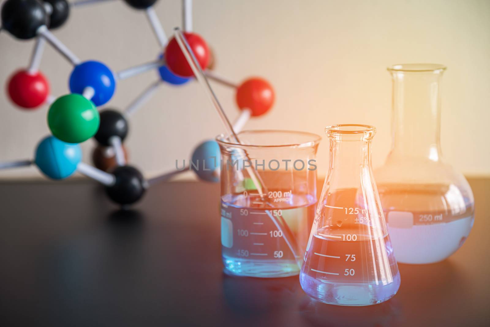 science laboratory beaker, erlenmeyer flask and molecule structure model, laboratory equipment concept