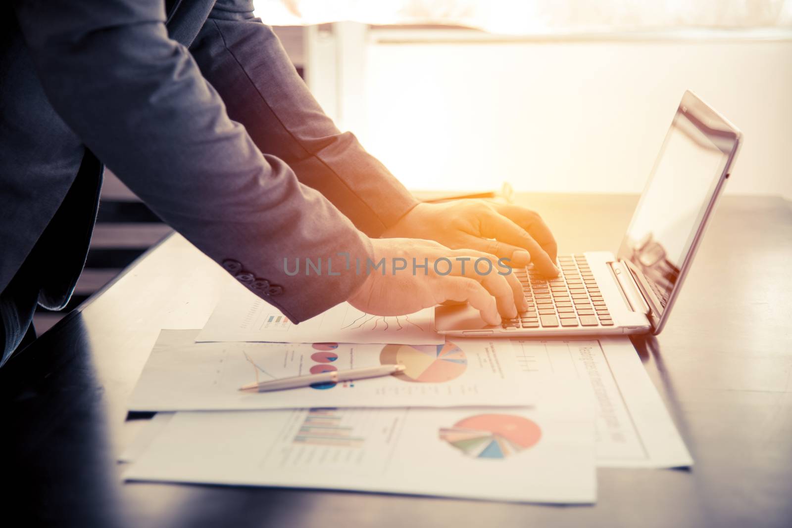 businessman working with laptop and business document on the work table, retro tone