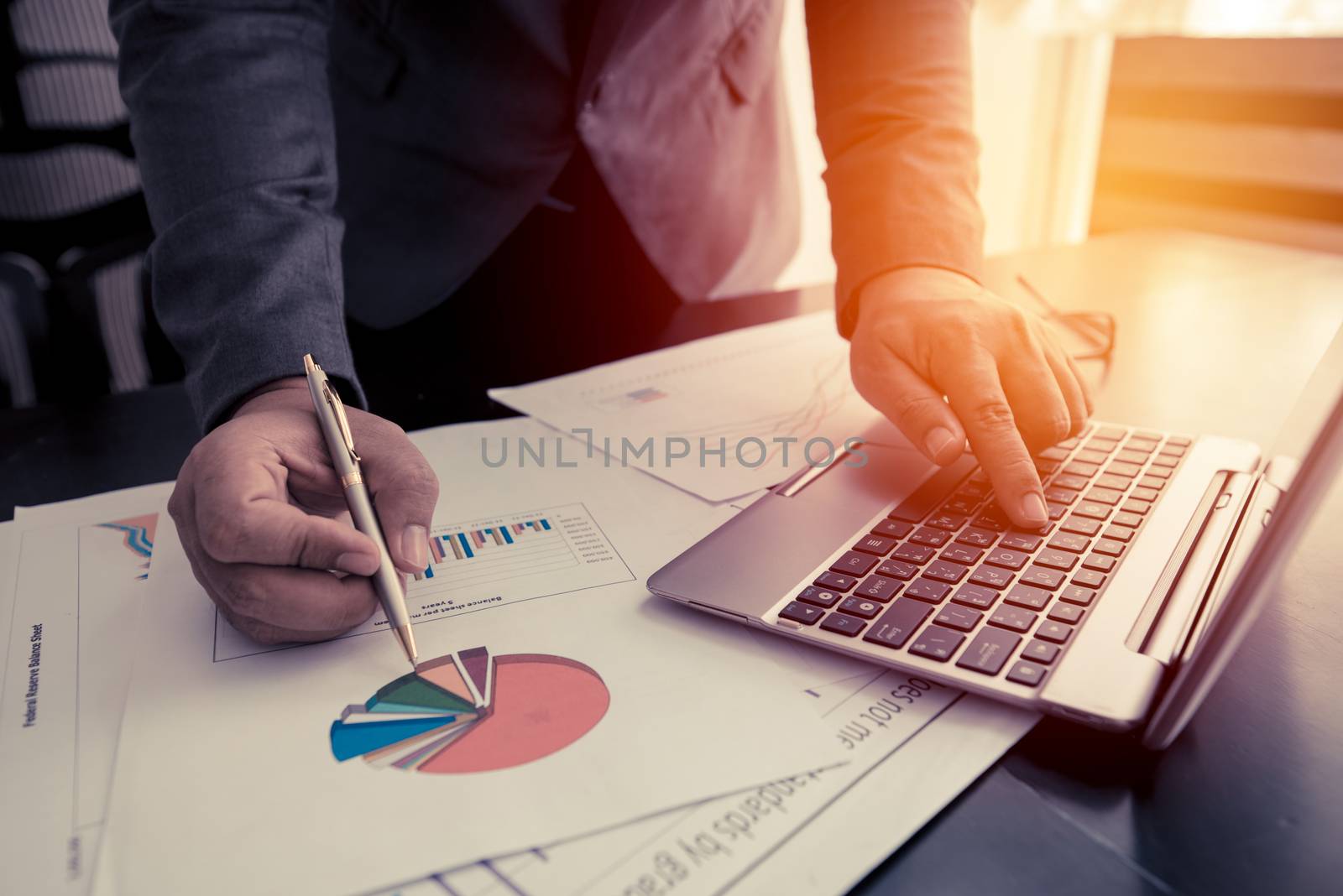 businessman working with laptop and business document on the work table, retro tone