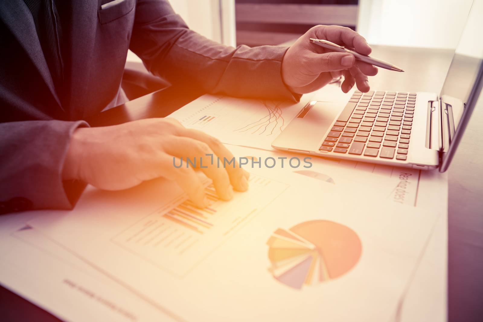 businessman working with laptop and business document on the work table, retro tone