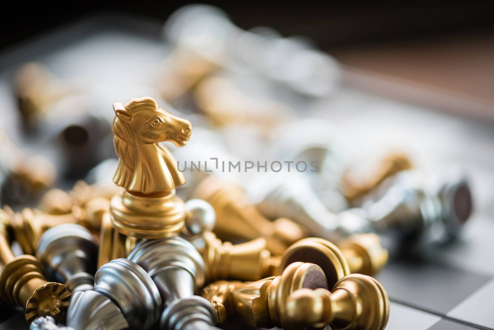 gold horse chess on top of another chess