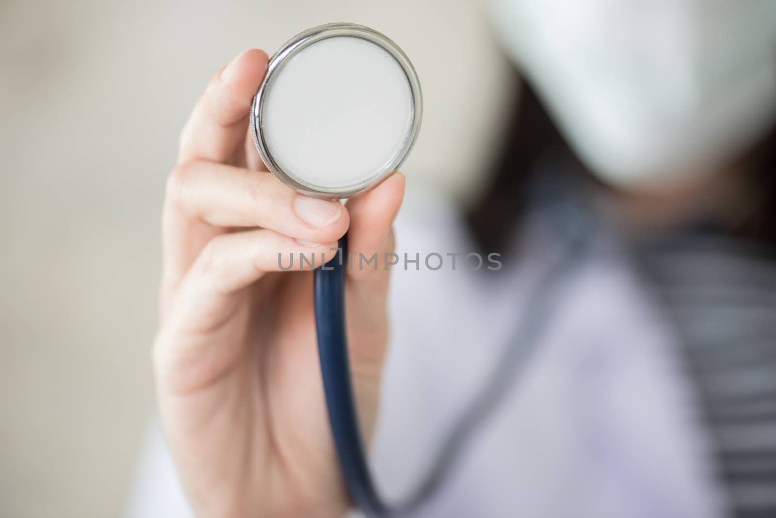 confidential woman doctor with green stethoscope in hand