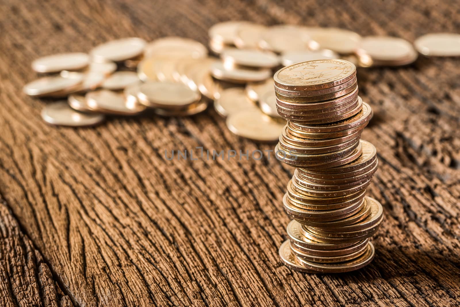 stack of dollars money coin on grunge wooden background