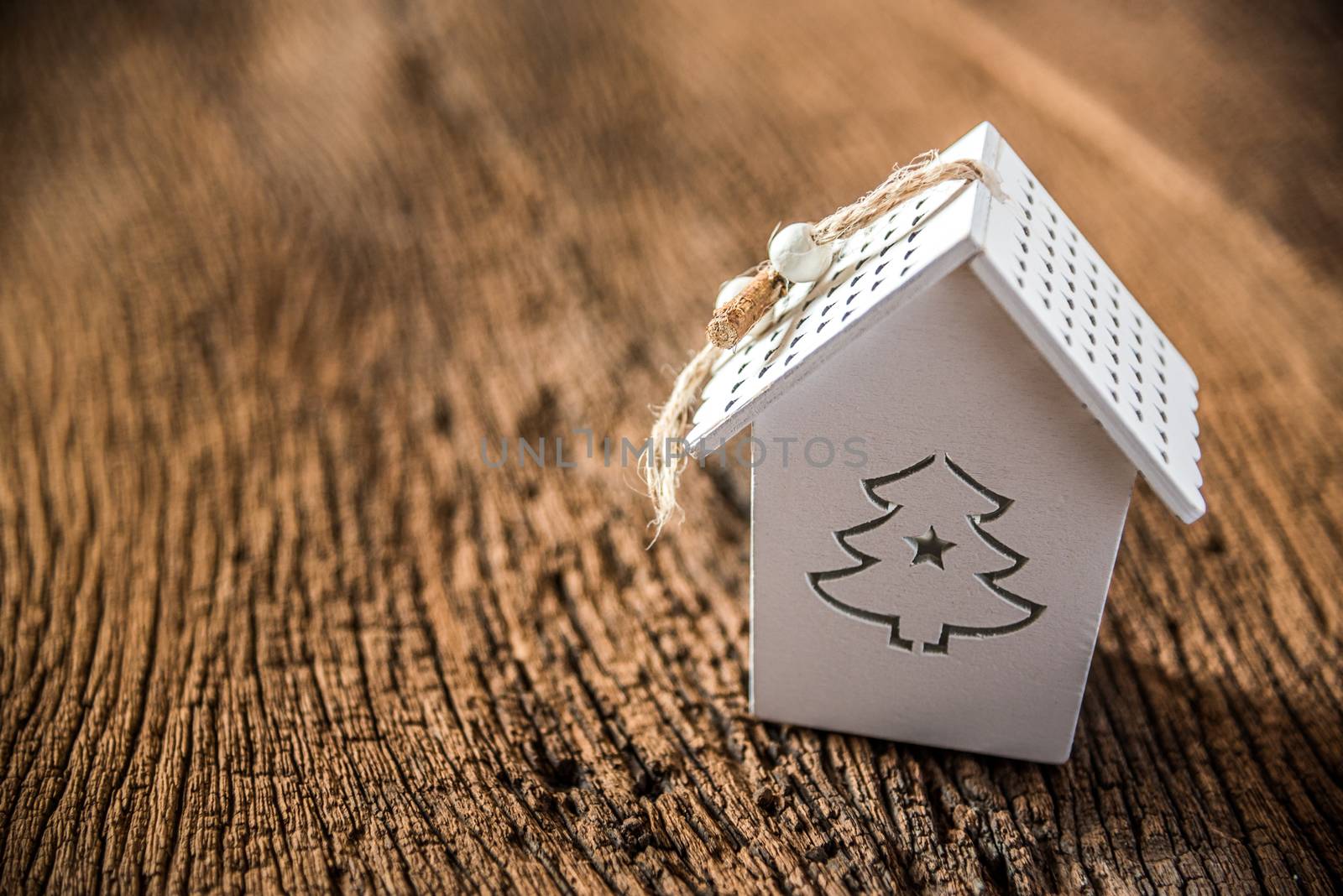 white christmas tree house on grnage wooden background