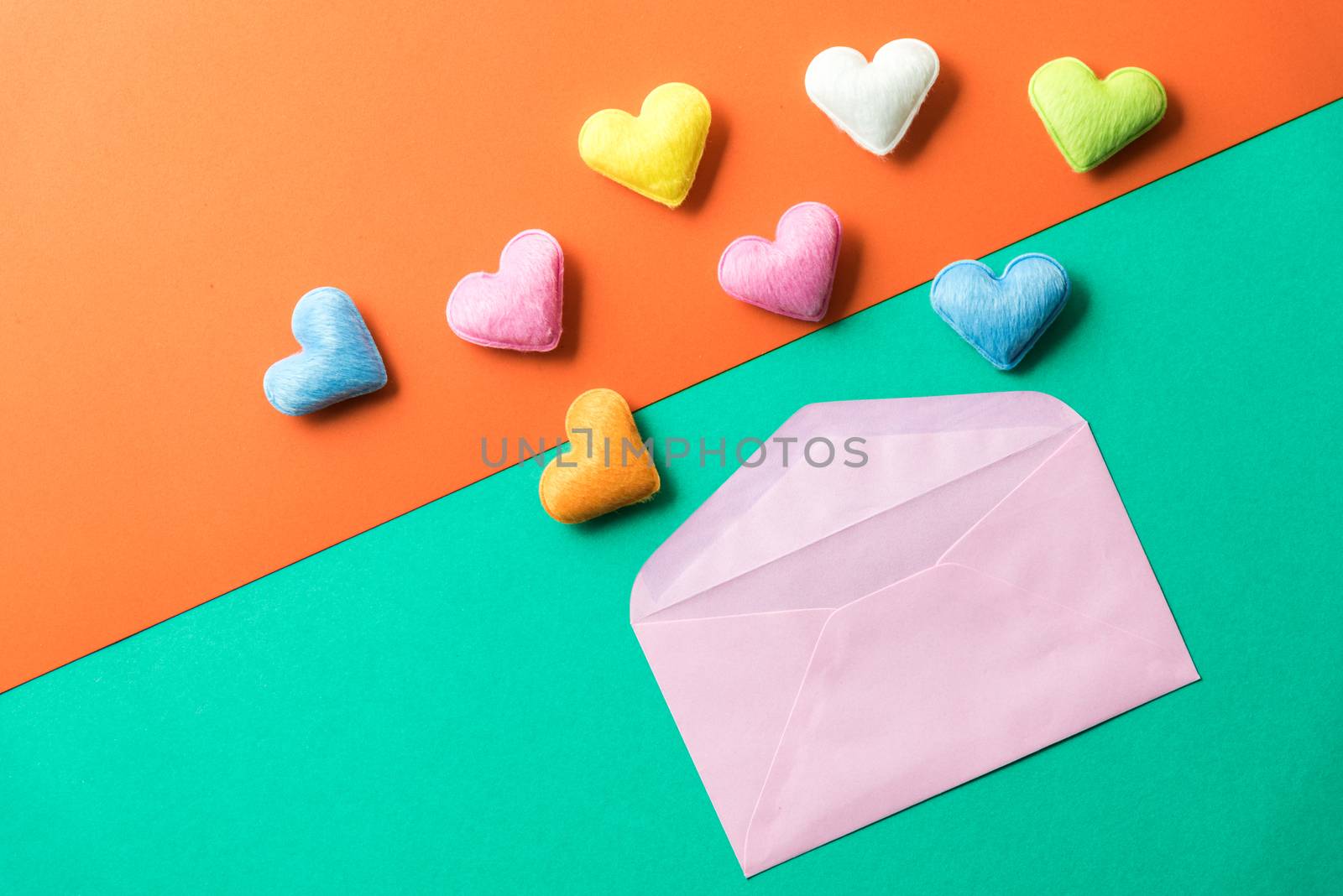 mini heart splash out from pink envelop , valentine concept