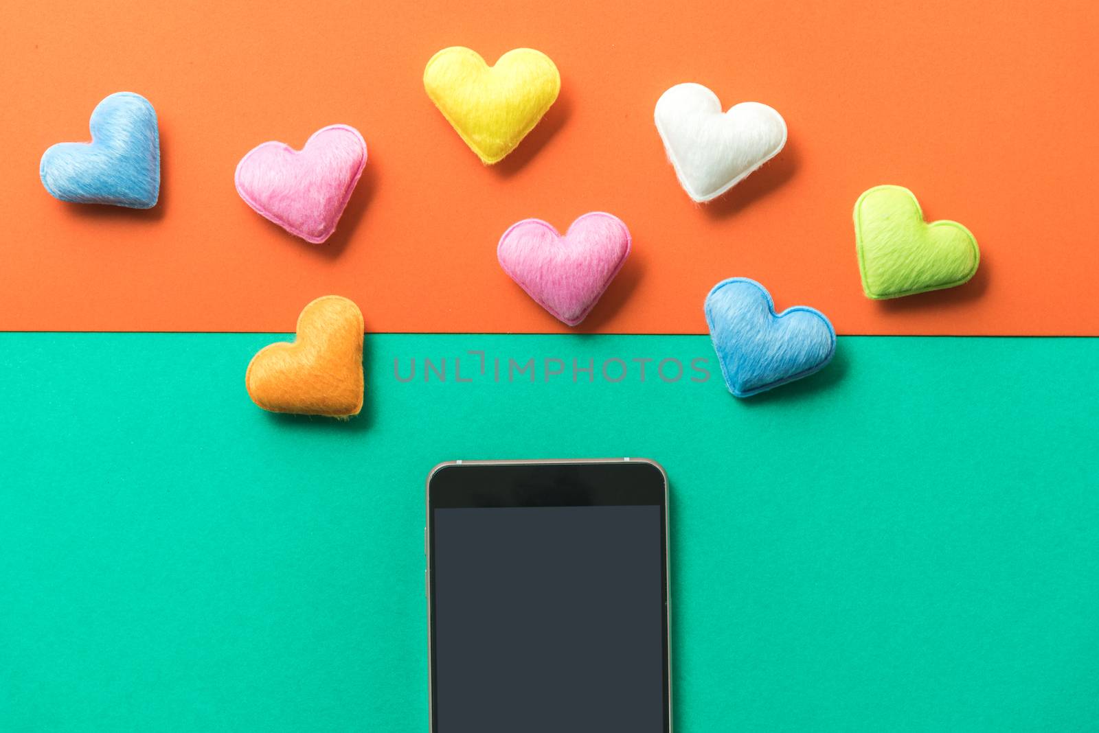 mini heart splash out from smart phone , valentine concept