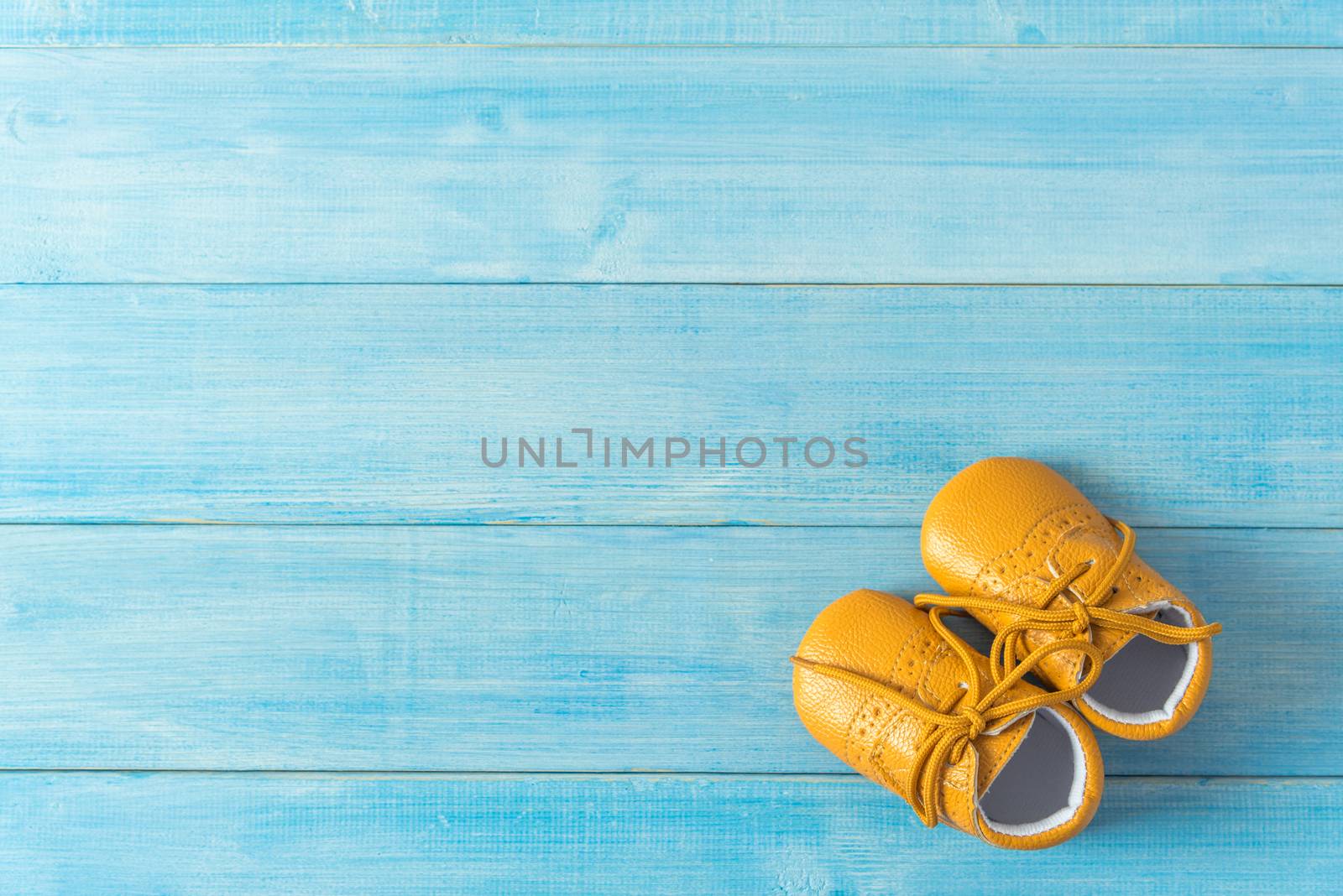 kids fashion shoes on light blue wood plank background