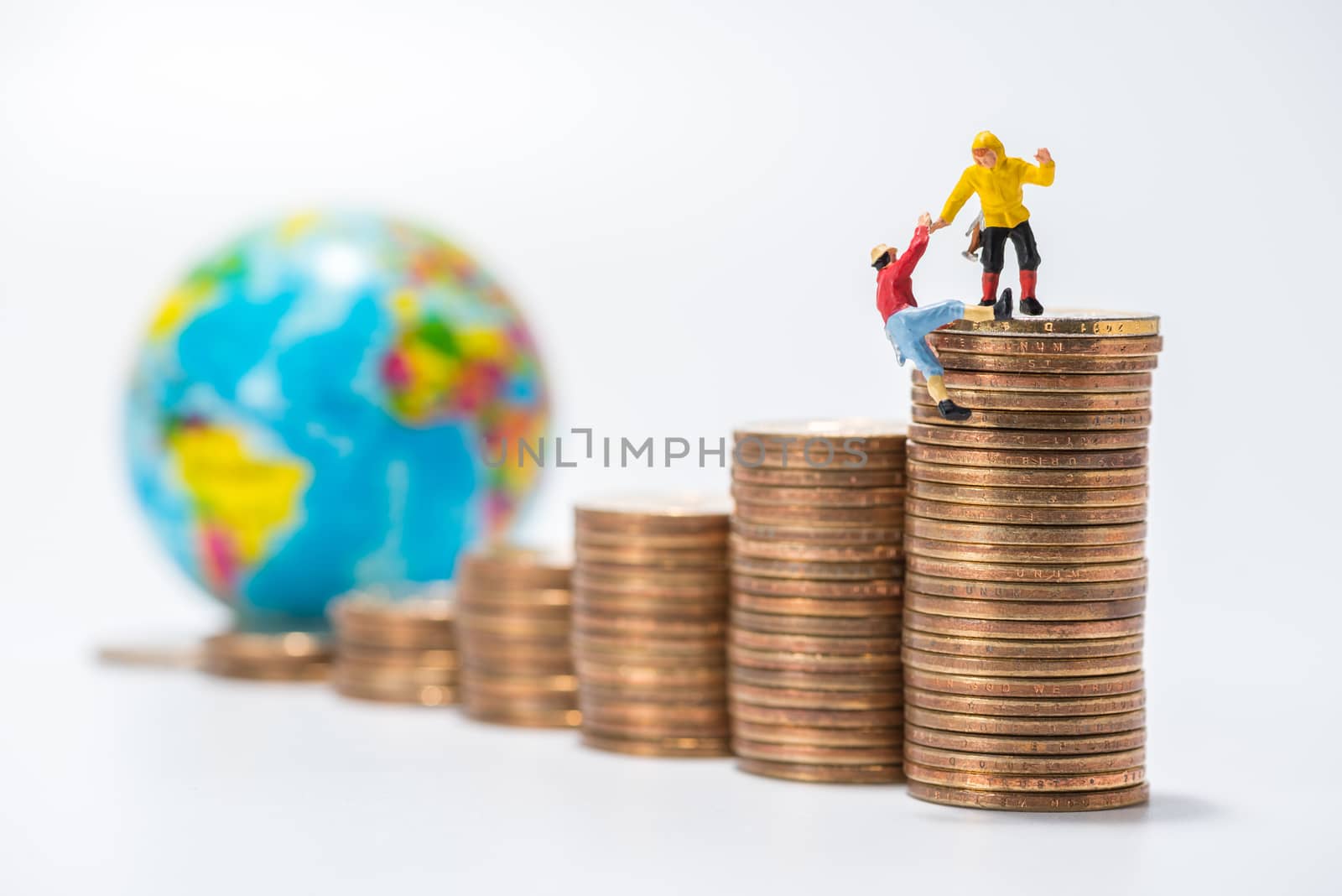 business miniature figure standing on stack of coins and globe figure background