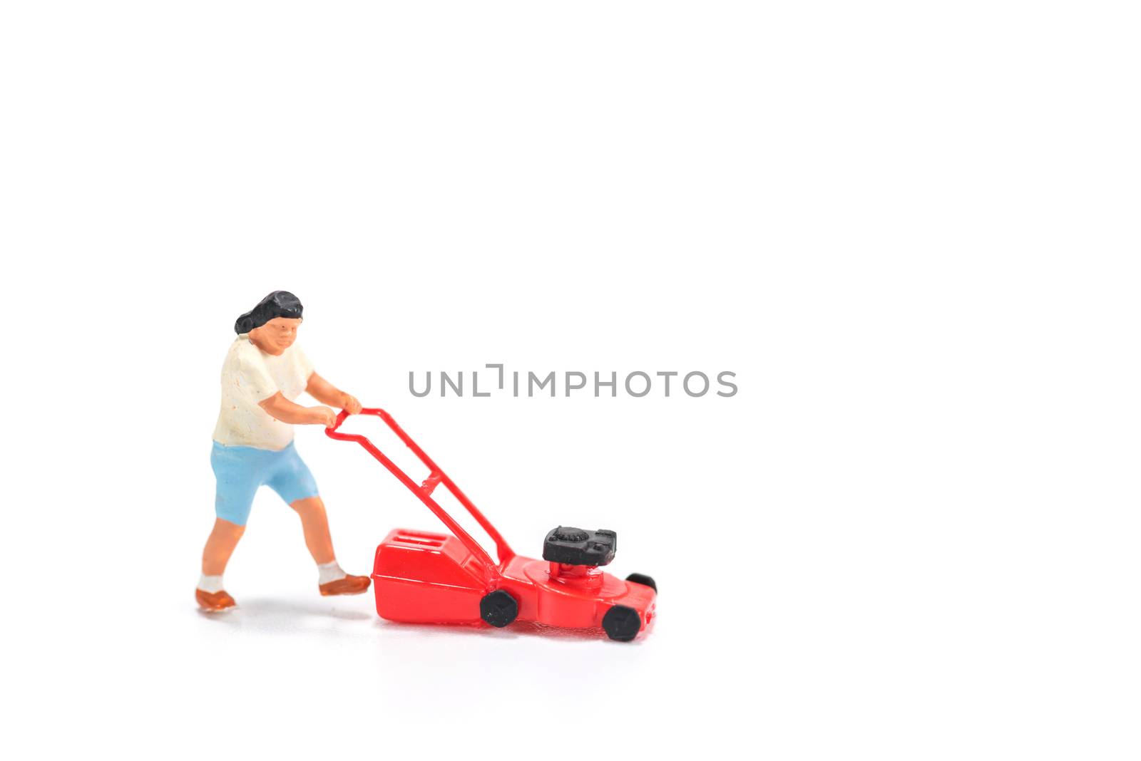 miniature people figure holding mower isolated on white background
