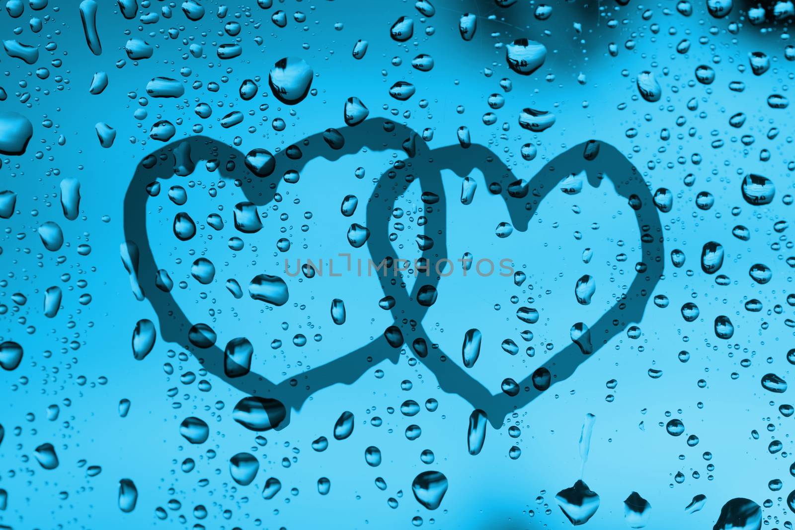 couple heart draw on water drops  glass window
